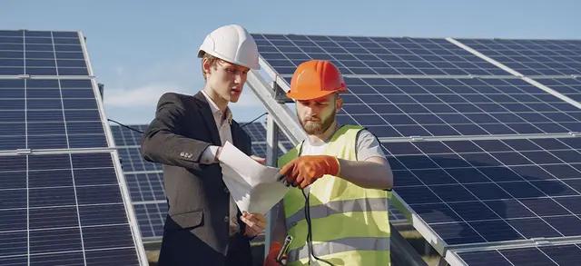 DUAS PESSOAS VISUALIZANDO E ORGANIZANDO UM DOCUMENTO DE HOMOLOGAÇÃO DA ENERGIA SOLAR